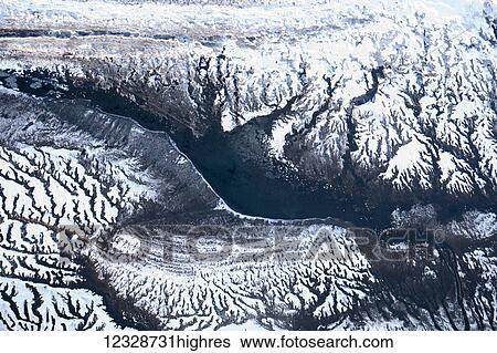 Aerial view of the mountainous landscape in winter with unique branching patterns, Kachemak Bay; Alaska, United States of America View Large Photo Image Stock Photograph - Aerial view of the mountainous landscape in winter with unique branching patterns, Kachemak Bay; Alaska, United States of America. Fotosearch