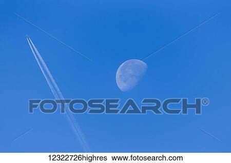 Airliner passing in front of the waning moon; South Dakota, United States of America View Large Photo Image Stock Photograph - Airliner passing in front of the waning moon; South Dakota, United States of America. Fotosearch
