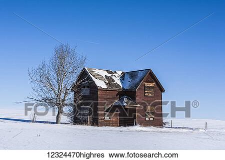 An old wooden house abandoned in a snow covered field with a blue sky; Orion, Alberta, Canada View Large Photo Image Stock Photograph - An old wooden house abandoned in a snow covered field with a blue sky; Orion, Alberta, Canada. Fotosearch