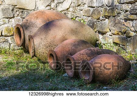 Stock Photograph - Ancient wine jugs and pitchers of different sizes found at the Ikalto Monastery; Kakheti region, Georgia. Fotosearch