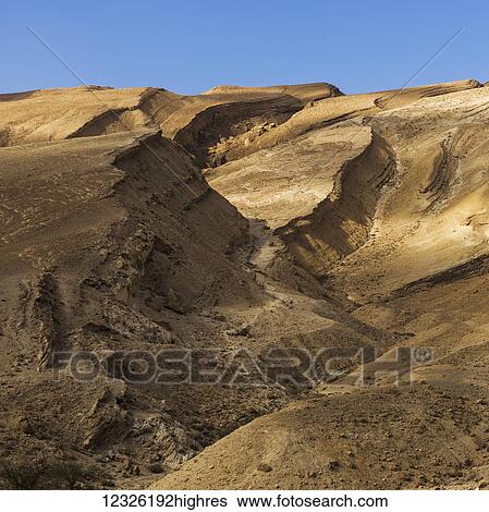 Stock Photograph - Arid and barren landscape in the Arava valley, Negev Desert; Har Hanegev Hatzfoni, South District, Israel. Fotosearch