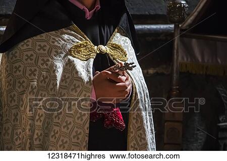 Armenian priest holding a crucifix at the Church of the Holy Mother of God in Geghard Monastery, Azat Valley; Kotayk, Armenia View Large Photo Image Stock Photograph - Armenian priest holding a crucifix at the Church of the Holy Mother of God in Geghard Monastery, Azat Valley; Kotayk, Armenia. Fotosearch
