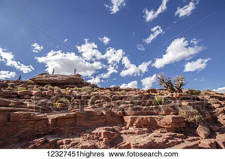 Stock Photograph - At Eagle Point in West Grand Canyon, tourists climb the steep mountain ranges for great viewpoints and photo opportunities from the top of this lookout hiking trail; Arizona, United States of America. Fotosearch