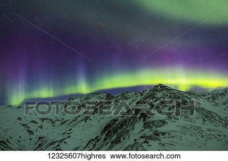 Aurora borealis over mountains within Denali National Park on a very cold winter night. The Andromeda Galaxy is visible to the left; Alaska, United States of America View Large Photo Image Stock Photograph - Aurora borealis over mountains within Denali National Park on a very cold winter night. The Andromeda Galaxy is visible to the left; Alaska, United States of America. Fotosearch