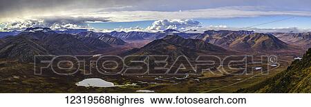 Stock Photograph - Autumn colours in the Blackstone valley with the West Blackstone River flowing through it towards the Dempster Highway; Yukon, Canada. Fotosearch