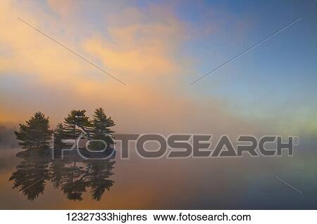 Stock Photograph - Autumn sunrise at Dollar Lake, Dollar Lake Provincial Park; Nova Scotia, Canada. Fotosearch