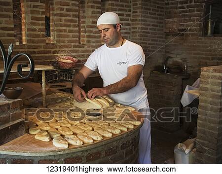 Baker making Tonis puri, a type of Georgian bread, at the Bread House Georgian Restaurant; Tbilisi, Georgia View Large Photo Image Stock Photograph - Baker making Tonis puri, a type of Georgian bread, at the Bread House Georgian Restaurant; Tbilisi, Georgia. Fotosearch