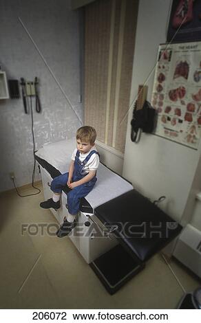 Boy sitting on examination room table View Large Photo Image Stock Image - Boy sitting on examination room table. Fotosearch