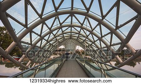 Bridge of Peace, a bow-shaped pedestrian bridge over the Mtkvari (Kura) River and Metekhi Church; Tbilisi, Georgia View Large Photo Image Stock Photograph - Bridge of Peace, a bow-shaped pedestrian bridge over the Mtkvari (Kura) River and Metekhi Church; Tbilisi, Georgia. Fotosearch