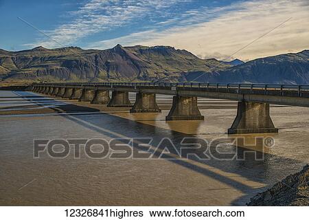Stock Photograph - Bridge over a glacial river along the South coast of Iceland; Iceland. Fotosearch