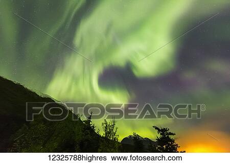 Bright green aurora borealis dances over the Kenai Mountains, Moose Pass, Kenai Peninsula, South-central Alaska; Alaska, United States of America View Large Photo Image Stock Photograph - Bright green aurora borealis dances over the Kenai Mountains, Moose Pass, Kenai Peninsula, South-central Alaska; Alaska, United States of America. Fotosearch