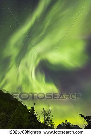 Bright green aurora borealis dances over the Kenai Mountains, Moose Pass, Kenai Peninsula, South-central Alaska; Alaska, United States of America View Large Photo Image Stock Photograph - Bright green aurora borealis dances over the Kenai Mountains, Moose Pass, Kenai Peninsula, South-central Alaska; Alaska, United States of America. Fotosearch