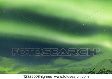 Stock Photograph - Bright green Aurora Borealis dances over the Kenai Mountains, Moose Pass, Kenai Peninsula, South-central Alaska; Alaska, United States of America. Fotosearch