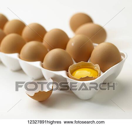 Stock Photograph - Brown eggs in a styrofoam carton on a white background. Fotosearch