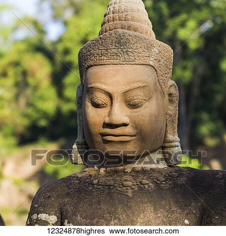 Stock Photograph - Buddha statue, South Gate, Angkor Thom; Krong Siem Reap, Siem Reap Province, Cambodia. Fotosearch