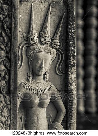 Stock Photograph - Buddhist figure carved in stone at a buddhist temple; Angkor Wat; Krong Siem Reap, Siem Reap Province, Cambodia. Fotosearch