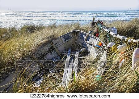 Buoys and a wooden boat on the shore among tall grasses with rough waves in the ocean View Large Photo Image Stock Photograph - Buoys and a wooden boat on the shore among tall grasses with rough waves in the ocean. Fotosearch
