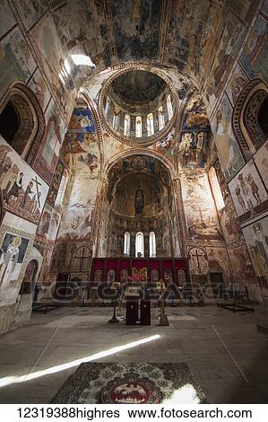 Stock Photograph - Central mosaic of the Virgin and Child, with Archangels Michael and Gabriel, above the ico0stasis and frescoes in the interior of the Church of the Virgin at Gelati Monastery; Imereti, Georgia. Fotosearch