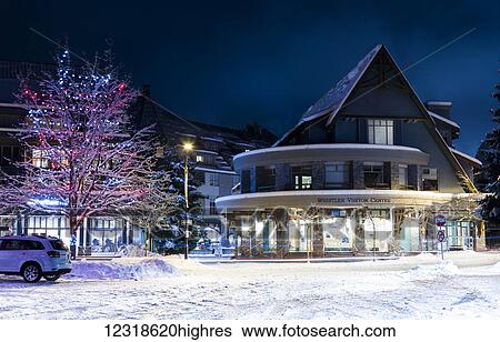 Stock Photograph - Christmas lights and fresh s0w at the Whistler Village Visitor Centre; Whistler, British Columbia, Canada. Fotosearch