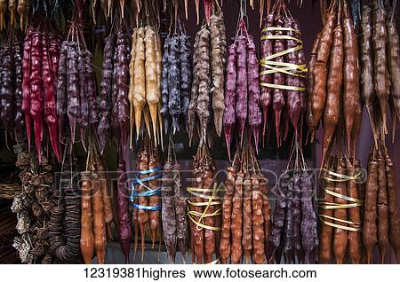 Stock Photograph - Churchkhela, traditional Georgian candies made from nuts, almonds, walnuts and hazelnuts threaded onto a string, dipped in thickened grape juice or fruit juices and dried; Tbilisi, Georgia. Fotosearch