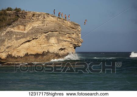 Cliff jumping, Keoniloa Beach and Bay, also k0wn as Ship Wreck Beach; Poipu, Kauai, Hawaii, United States of America View Large Photo Image Stock Photograph - Cliff jumping, Keoniloa Beach and Bay, also k0wn as Ship Wreck Beach; Poipu, Kauai, Hawaii, United States of America. Fotosearch