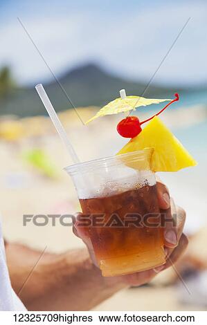Close-up of a man holding a mai tai drink with diamond head and waikiki beach in the background; Honolulu, Oahu, Hawaii, United States of America View Large Photo Image Stock Photograph - Close-up of a man holding a mai tai drink with diamond head and waikiki beach in the background; Honolulu, Oahu, Hawaii, United States of America. Fotosearch