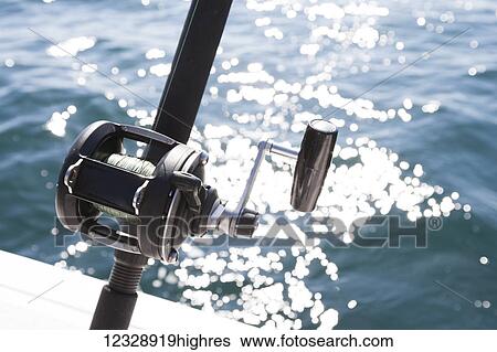 Close-up of the reel on a fishing rod and sparkling water from the sunlight; Homer, Alaska, United States of America View Large Photo Image Stock Photograph - Close-up of the reel on a fishing rod and sparkling water from the sunlight; Homer, Alaska, United States of America. Fotosearch