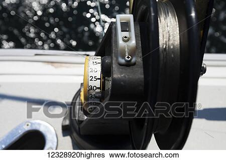Close-up of the reel on a fishing rod and the side of a boat; Homer, Alaska, United States of America View Large Photo Image Stock Photograph - Close-up of the reel on a fishing rod and the side of a boat; Homer, Alaska, United States of America. Fotosearch
