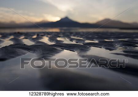 Stock Photograph - Close-up of the ripples and tide pools on the shores of the tidal flats at sunset; Homer, Alaska, United States of America. Fotosearch