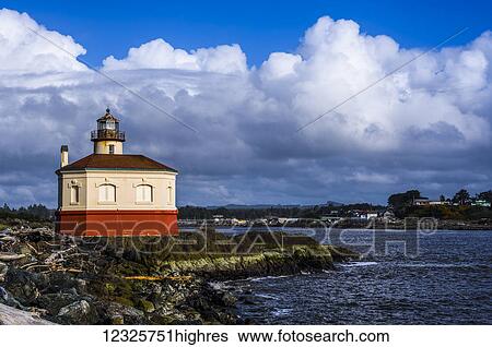 Stock Photograph - Clouds hover behind the Coquille River Lighthouse on the Oregon Coast; Bandon, Oregon, United States of America. Fotosearch