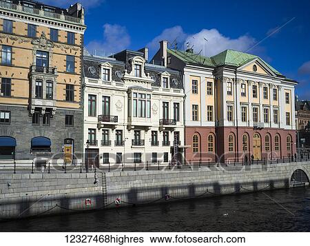 Stock Photograph - Colourful buildings along the water; Stockholm, Sweden. Fotosearch