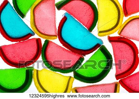 Stock Photograph - Colourful candied gummy fruit wedges backlit; Calgary, Alberta, Canada. Fotosearch