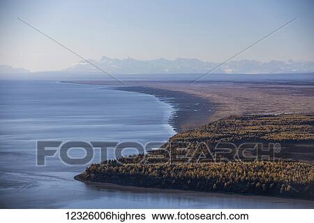 Cook Inlet and Point MacKenzie on a clear autumn day, the snow covered Tordrillo Mountains in the distance; South-central Alaska; Anchorage, Alaska, United States of America View Large Photo Image Stock Photograph - Cook Inlet and Point MacKenzie on a clear autumn day, the snow covered Tordrillo Mountains in the distance; South-central Alaska; Anchorage, Alaska, United States of America. Fotosearch