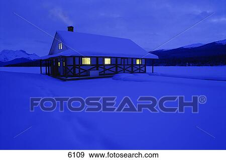 Stock Photo - Cottage with snowy backdrop. Fotosearch