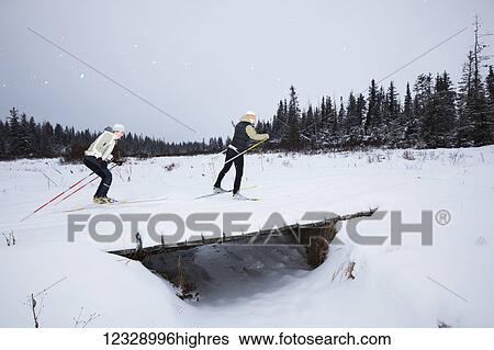 Cross country skiing across a small bridge in winter; Homer, Alaska, United States of America View Large Photo Image Stock Photograph - Cross country skiing across a small bridge in winter; Homer, Alaska, United States of America. Fotosearch