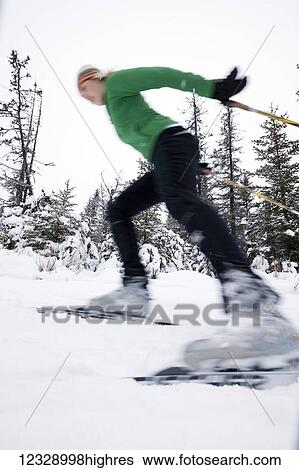 Stock Photograph - Cross country skiing on a trail through a forest; Homer, Alaska, United States of America. Fotosearch