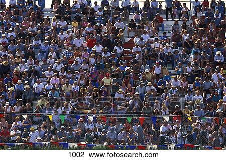 Crowd of people in stands at organized event View Large Photo Image Stock Image - Crowd of people in stands at organized event. Fotosearch