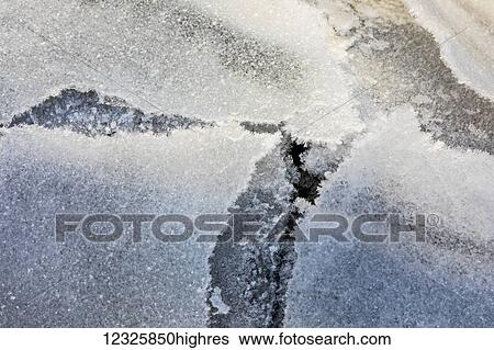 Stock Photograph - Detail view of frozen overflow ice on sea ice along Turnagain Arm in winter, South-central Alaska; Anchorage, Alaska, United States of America. Fotosearch