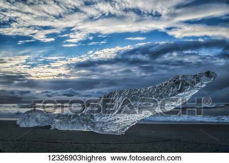 Stock Photograph - Diamond Beach, along the South Coast of Iceland and is an area where ice chunks from Jokulsarlon are deposited on the beach after each high tide; Iceland. Fotosearch