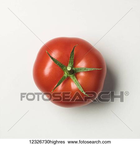 Stock Photograph - Directly above a ripe, red tomato on a white background. Fotosearch