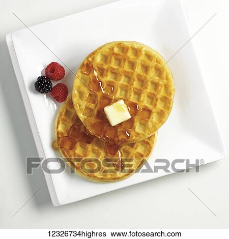 Directly above waffles with syrup and butter with berries on a white plate View Large Photo Image Stock Photograph - Directly above waffles with syrup and butter with berries on a white plate. Fotosearch