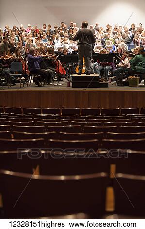 Stock Photograph - Director directing a choir during practice, Alaska, USA. Fotosearch