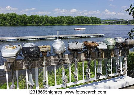 Stock Photograph - Display of antique outboard motors along the Mississippi River; Wabasha, Minnesota, United States of America. Fotosearch