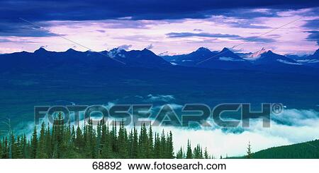 Stock Image - Distant mountain range on cloudy day. Fotosearch