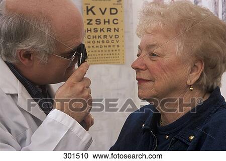 Stock Image - Doctor examining patient. Fotosearch