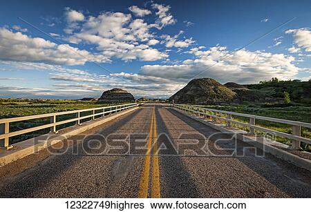 Stock Photograph - Double solid yellow line down a paved road; Herschel, Saskatchewan, Canada. Fotosearch