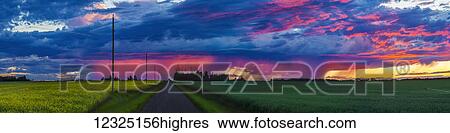 Dramatic colourful sky at sunset over green farmland and a country road; Alberta, Canada View Large Photo Image Stock Photograph - Dramatic colourful sky at sunset over green farmland and a country road; Alberta, Canada. Fotosearch