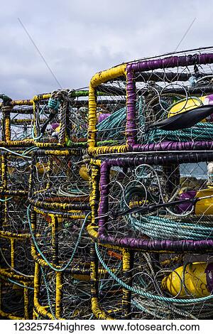 Stock Photograph - Dungeness Crab pots are stacked on the pier; Port Orford, Oregon, United States of America. Fotosearch