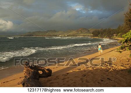 Stock Photograph - Early morning walk, Waipouli Beach; Wailua, Kauai, Hawaii, United States of America. Fotosearch