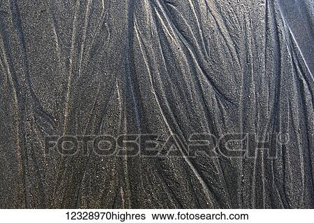 Stock Photograph - Extreme close-up of unique patterns of lines on the surface of the wet sand on the tidal flats; Alaska, United States of America. Fotosearch